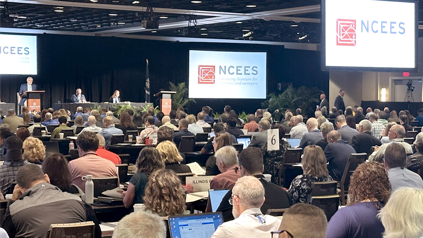 Large group of people listening to a speaker